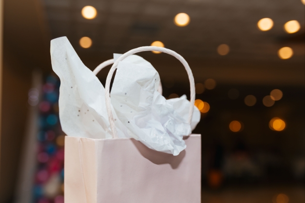 Tissue paper sticking out from the top of a paper gift bag