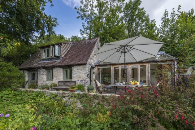 Patio shot of grey cottage in Dorset