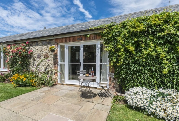 Front view shot of cottage covered in ivy