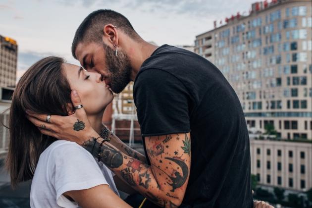 Couple snogging on top of a roof of a building