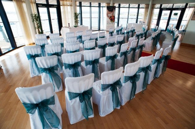 RNLI College, harbour view from ceremony room chairs in white with blue sash