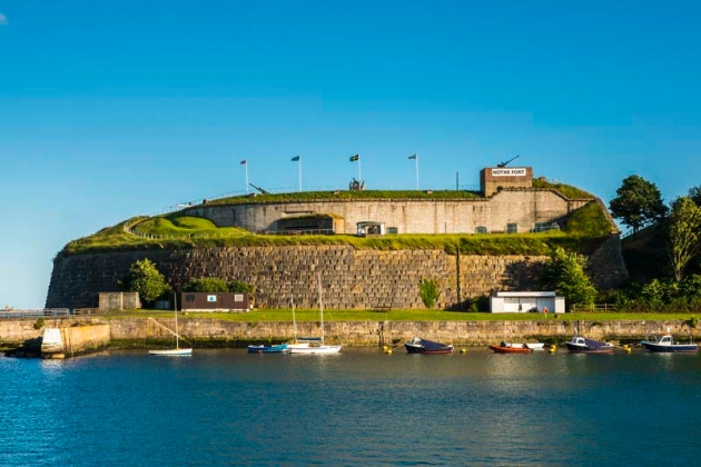 Nothe Fort, brick fort on hill harbour below sunny day