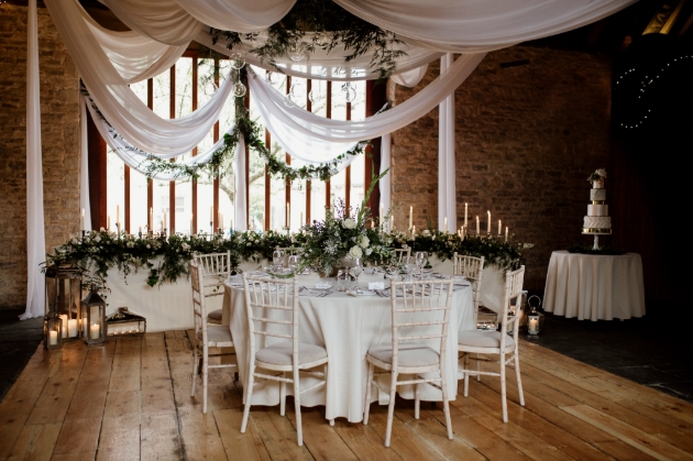 Kingston Country Courtyard, Corfe Castle, large window with draping from ceiling and tables set up for a wedding
