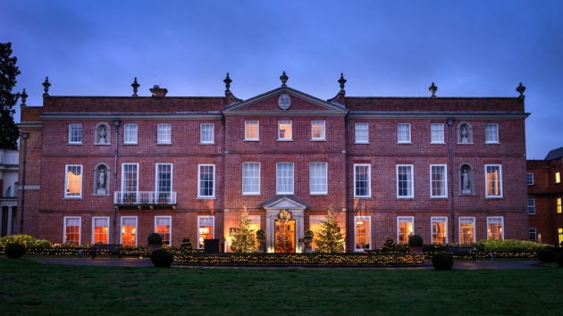 Four Seasons Hotel, red brick house, lit up at night by floodlights 