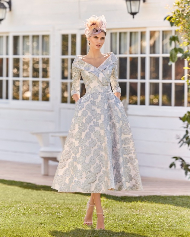 woman in patterned dress and matching hat 