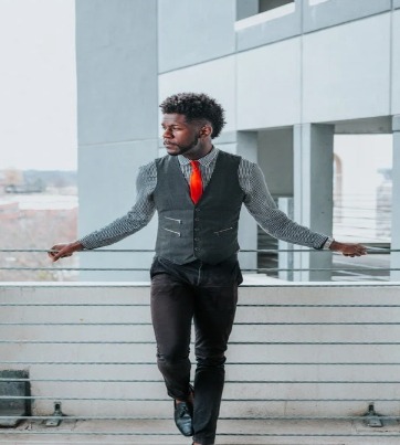 man in suit with orange tie