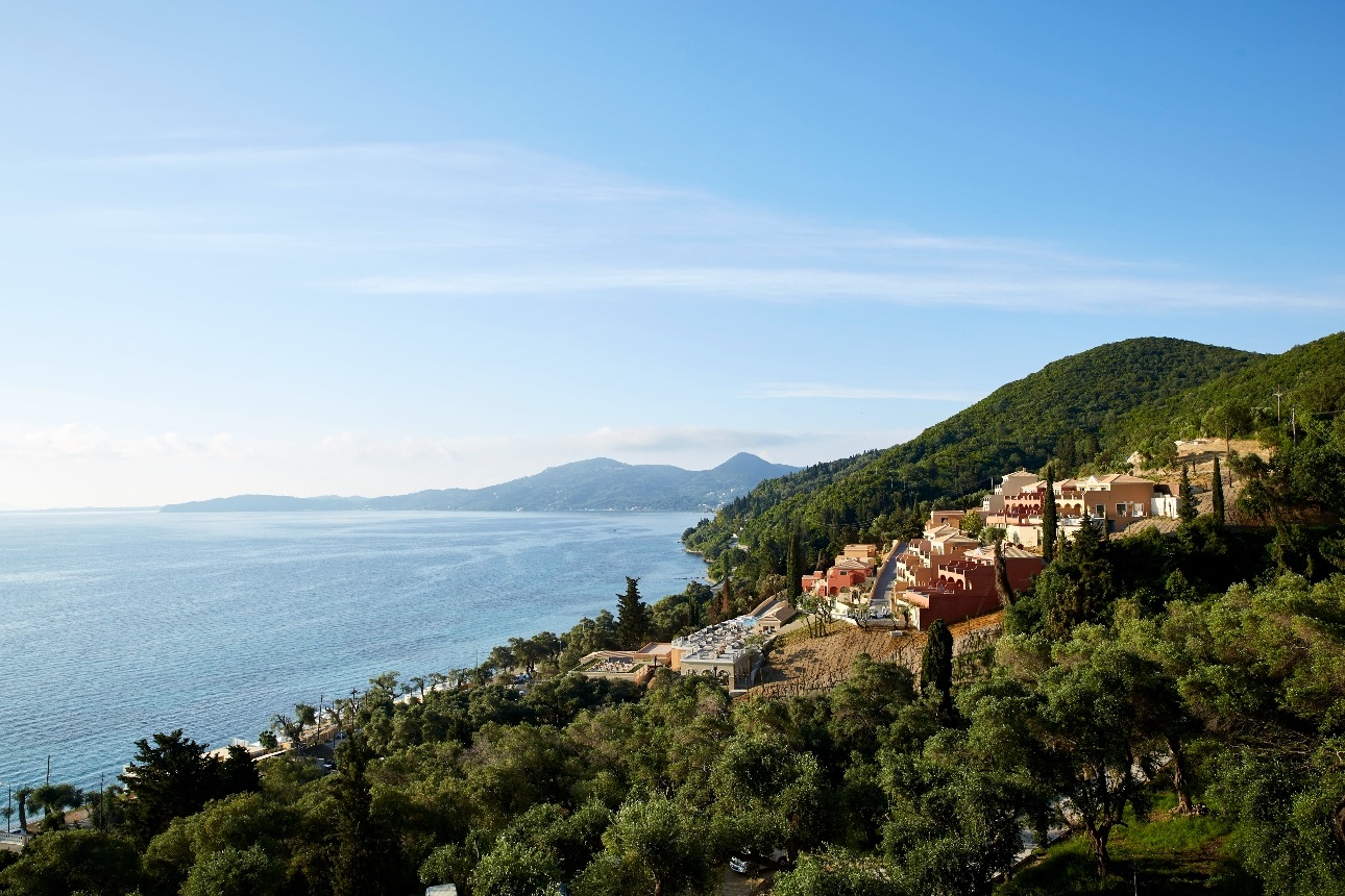 aerial shot of resort sunny day on the hills ocean in view