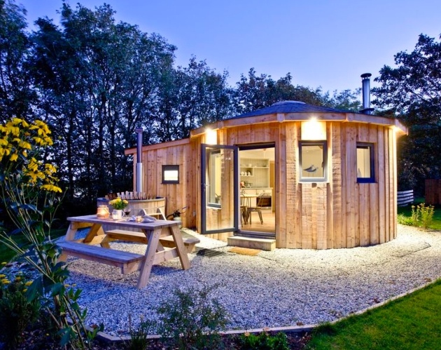 wooden house lit up at night 