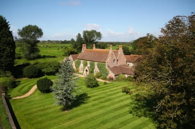 ivy clad cottage surrounded by countryside