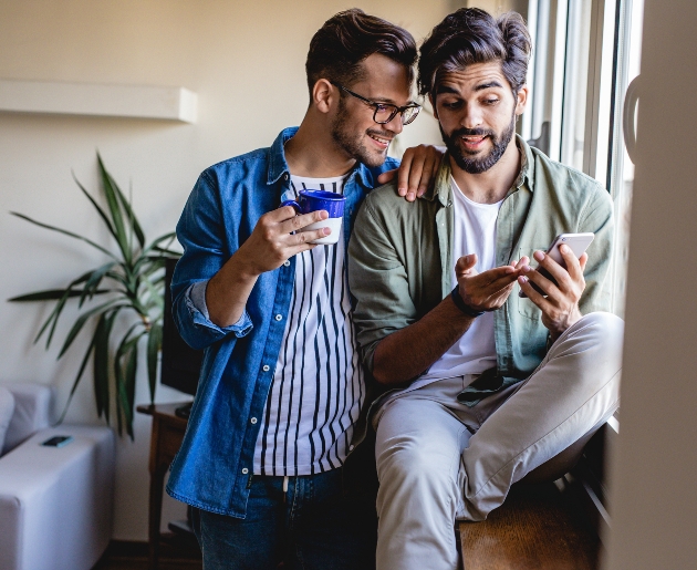 couple sitting together looking at their phone 