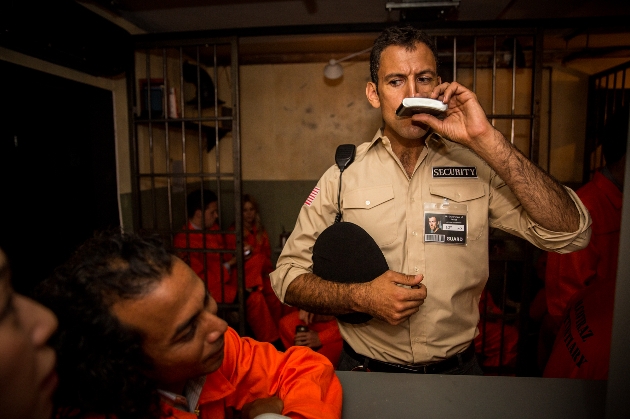 actors in prison guard and inmate outfits