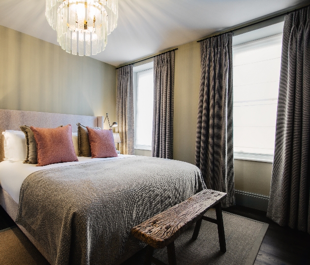 bed with chandelier above it 