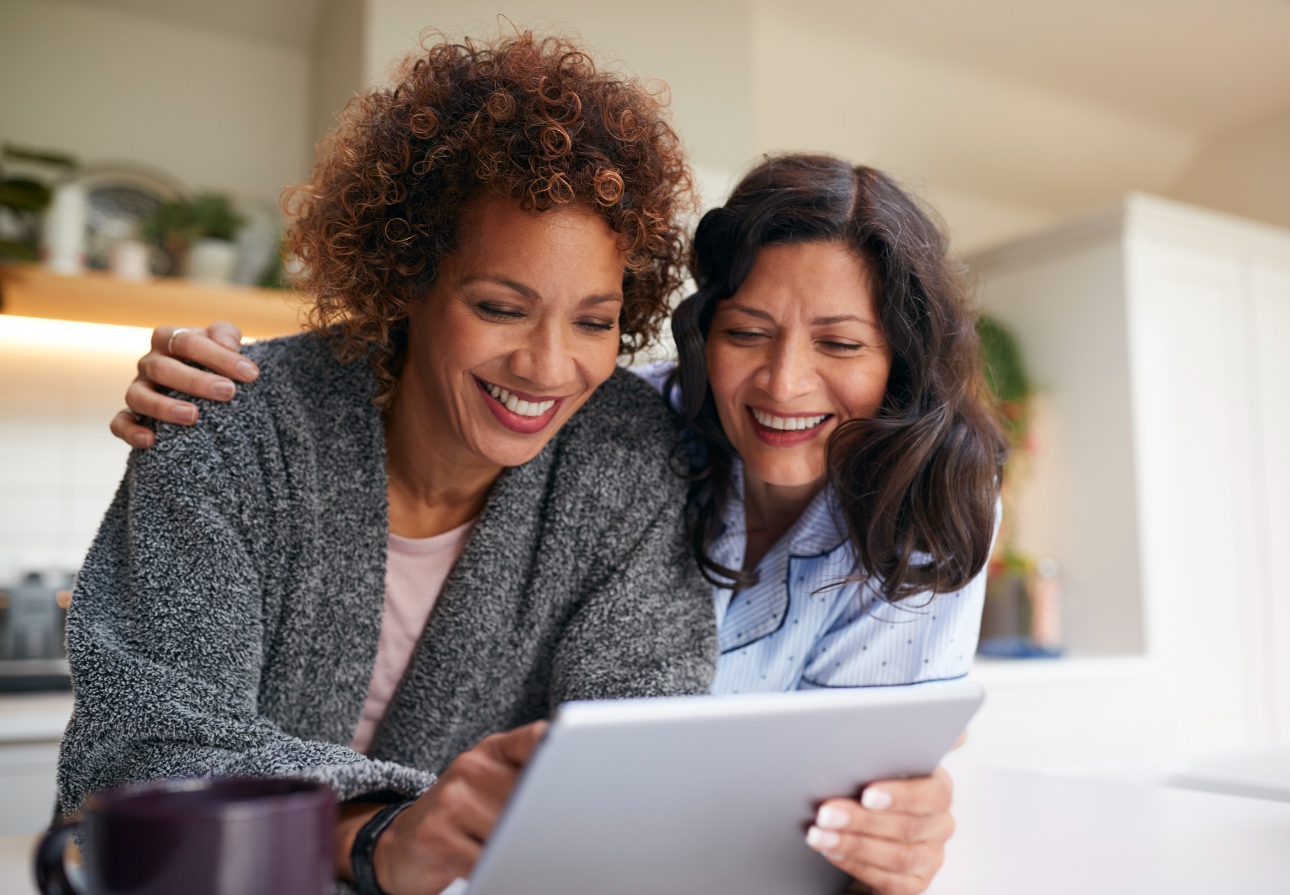 two women looking at a laptop