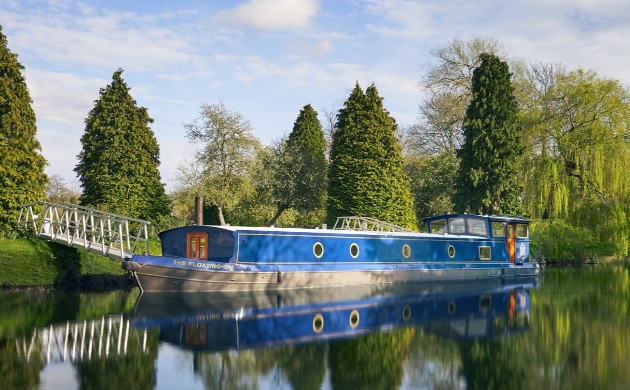 blue floating spa barge on water