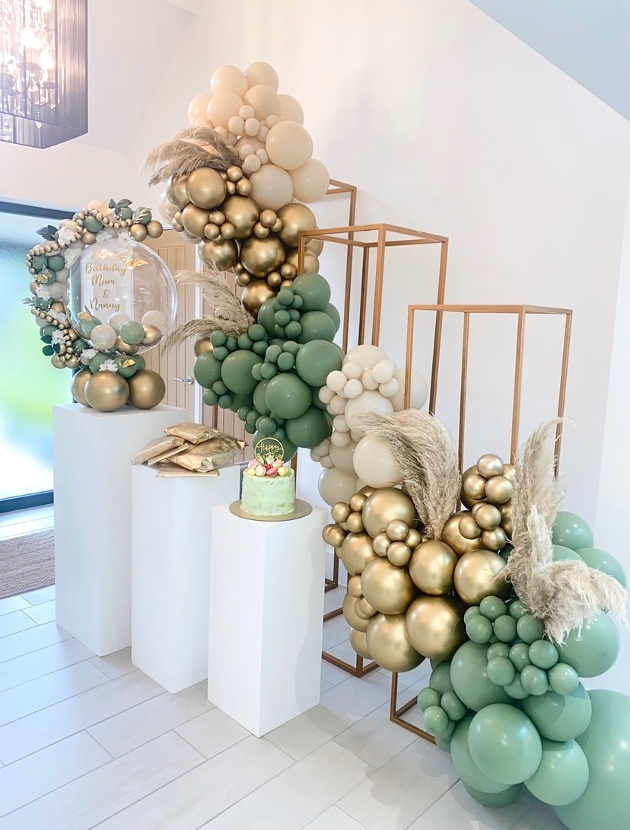 gold cream and green balloons in a modern display