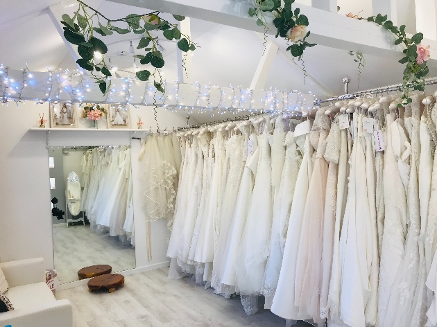 dresses on rails in a white barn style room