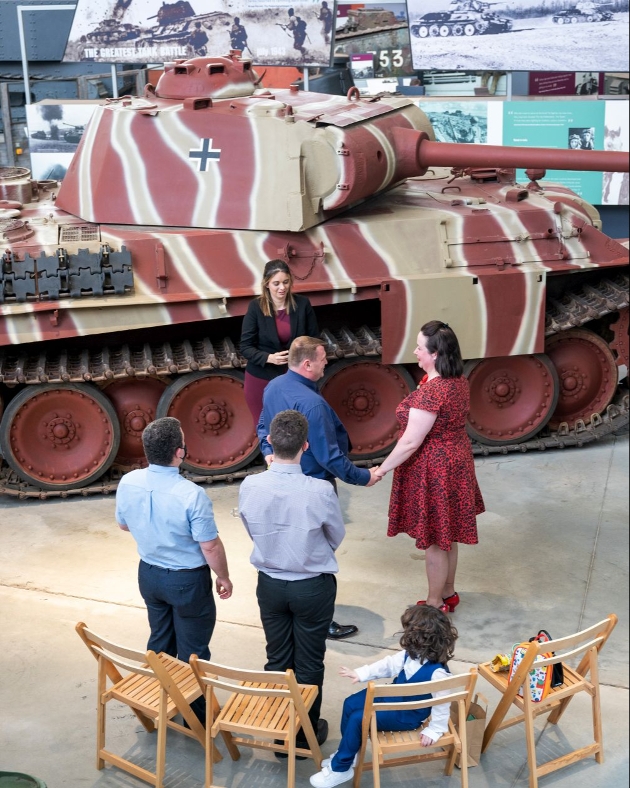 couple saying their vows in front of a WW1 tank