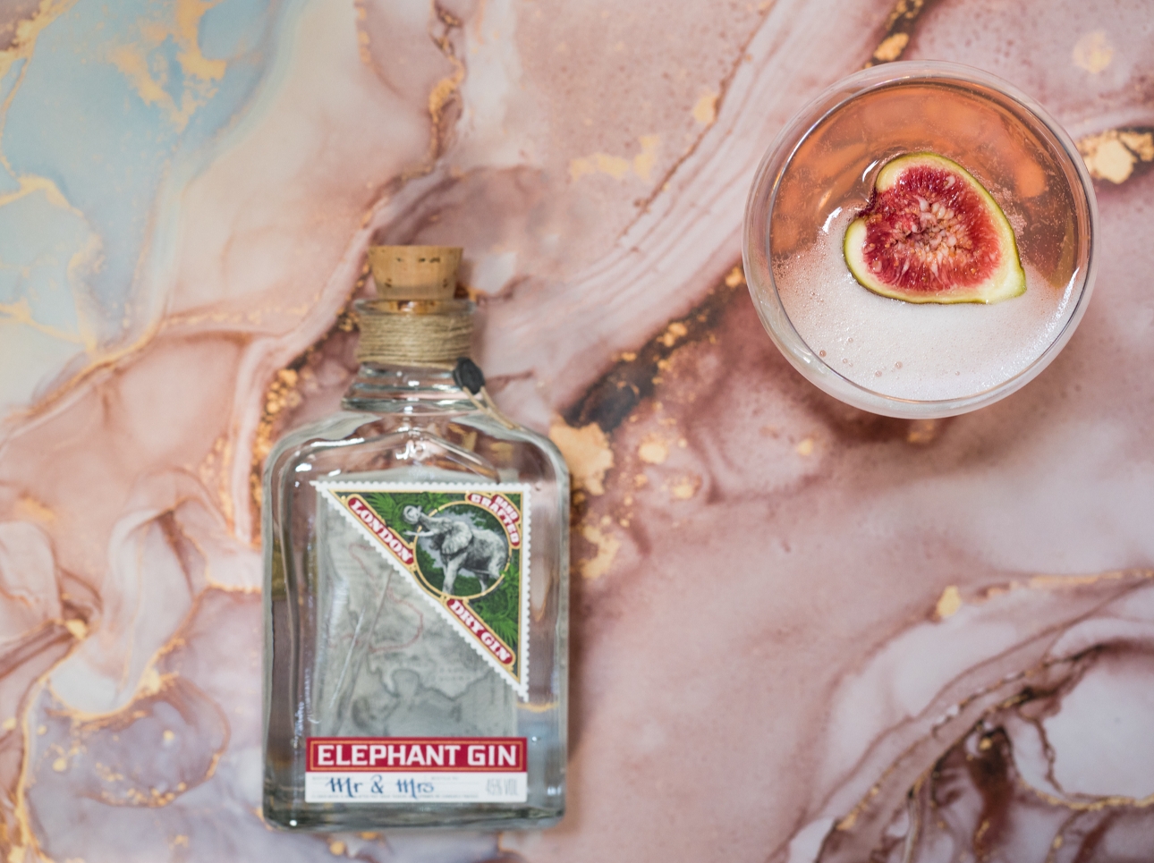 bottle of gin laying on a marbled background