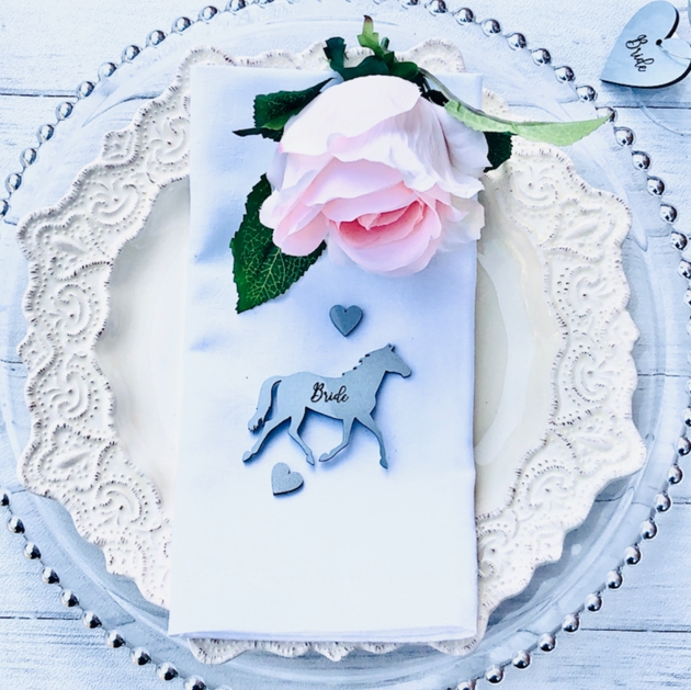 silver horse place name setting with bride in script font on it