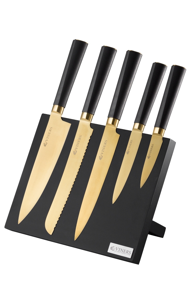 gold knives in a black knife rack