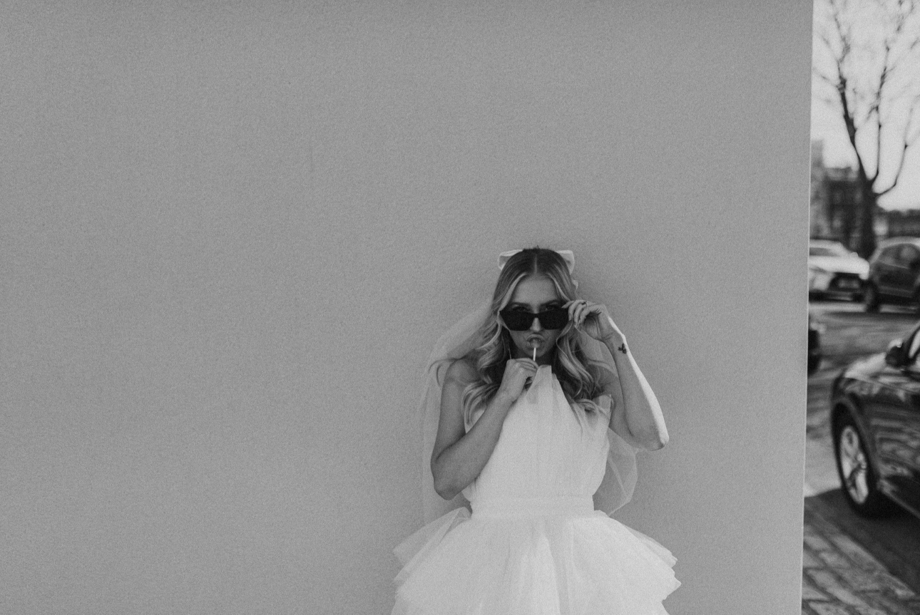 bride with sunglasses and a lollipop