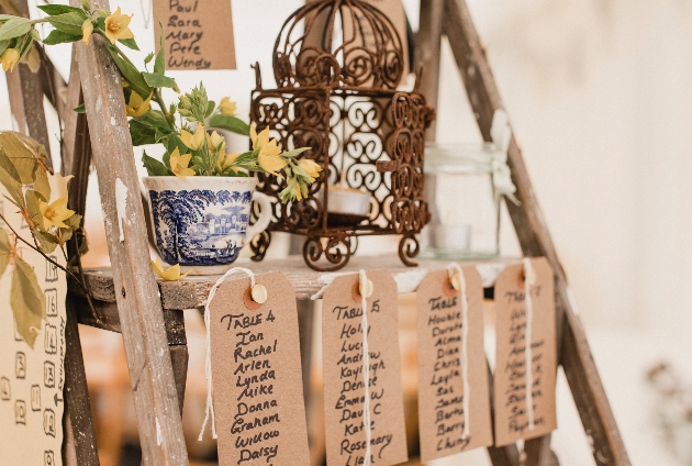 wedding guest names on tags on a ladder