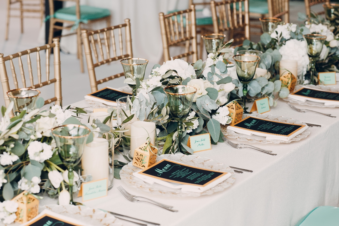 reception tables set up with flowers, place settings crockery and plates