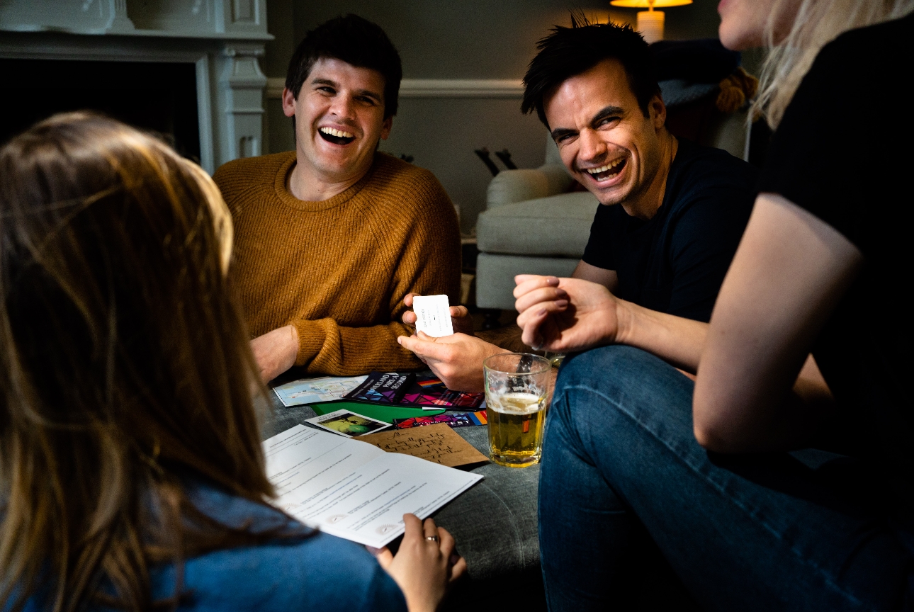 group of people round a table playing a game