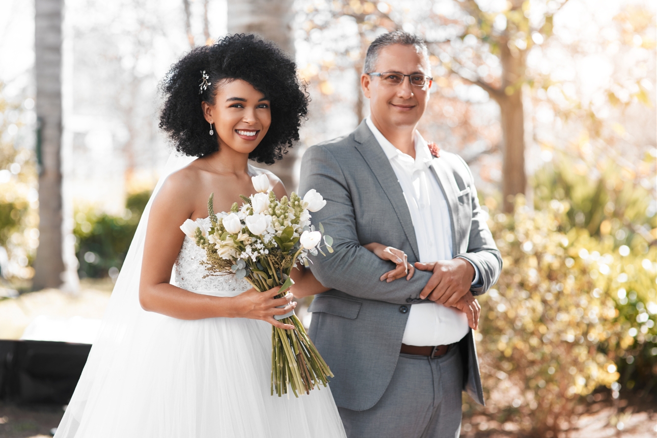 bride and her father walking down the aisle at an outdoor wedding