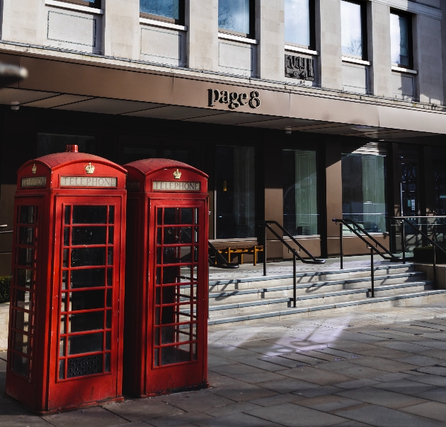 hotel on london street with two red telephone boxes outside