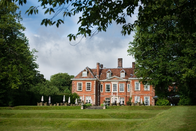 red and white Palladian manor house with lots of grounds
