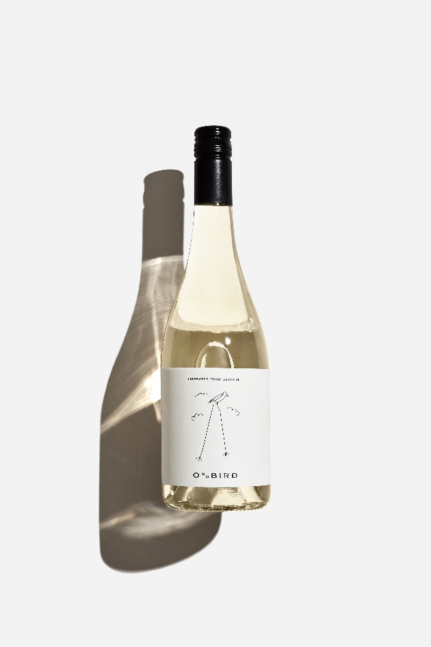 clear wine bottle with handdrawn oddbird logo on it