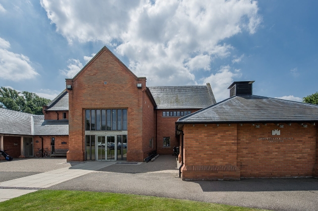 modern red brick building with floor-to-ceiling windows