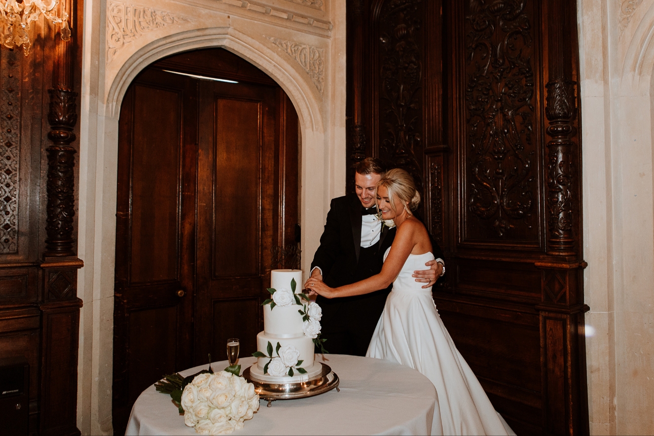 Couple cutting three tier cake