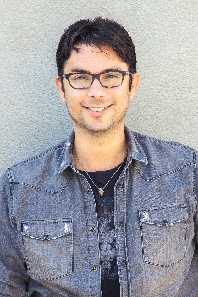 Multi award-winning wedding photographer head shot of man in denim shirt wearing glasses