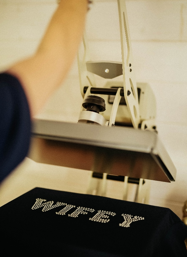 black t shirt under press with word wifey on it