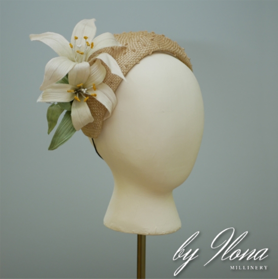 a vintage-style knotted straw bandeau, adorned with whimsical handmade silk lilies