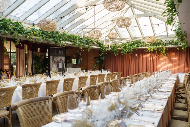 tables laid out for reception in conservatory style room