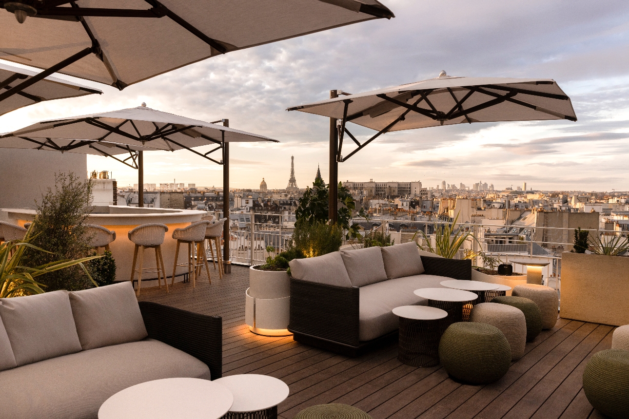 roof top terrace with chairs, tables, parasols, view of Paris