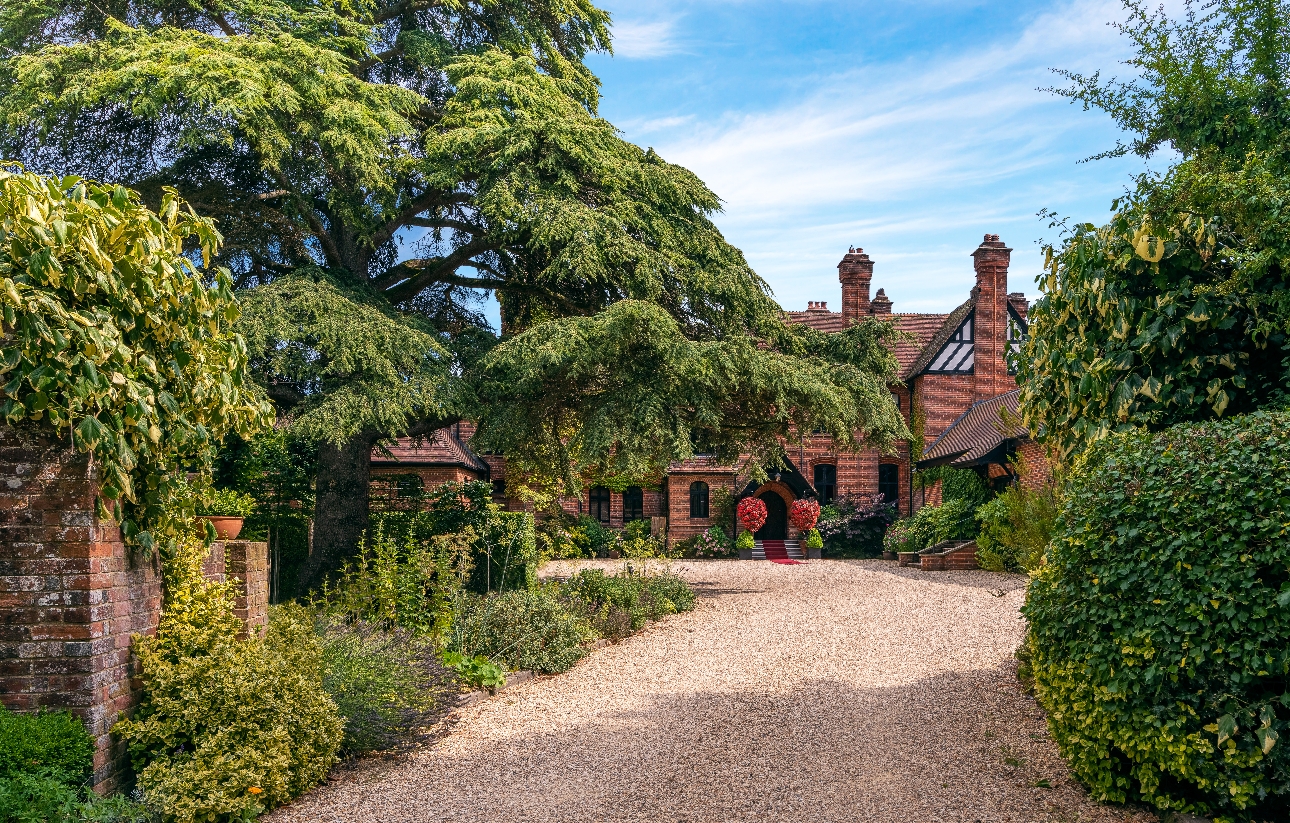 large country house, at end of gravel drive, trees and shrubland