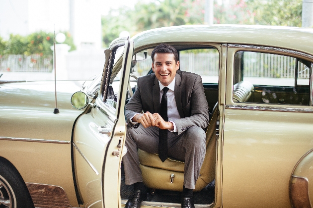 Man sitting in a car wearing a suit