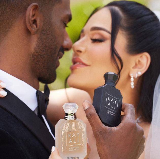 Groom & bride holding bottles.