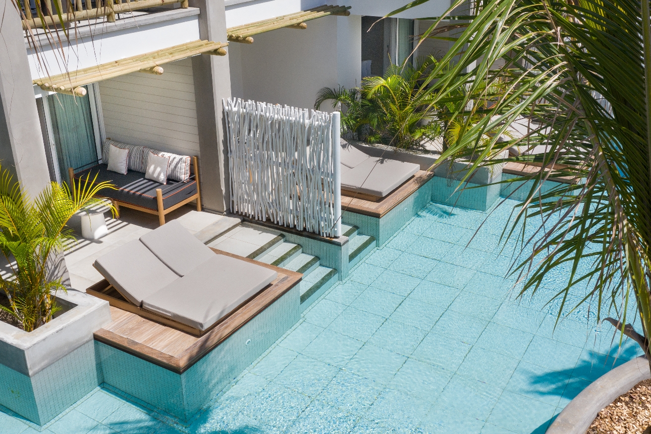 room terrace with swim up pool and lounger chairs