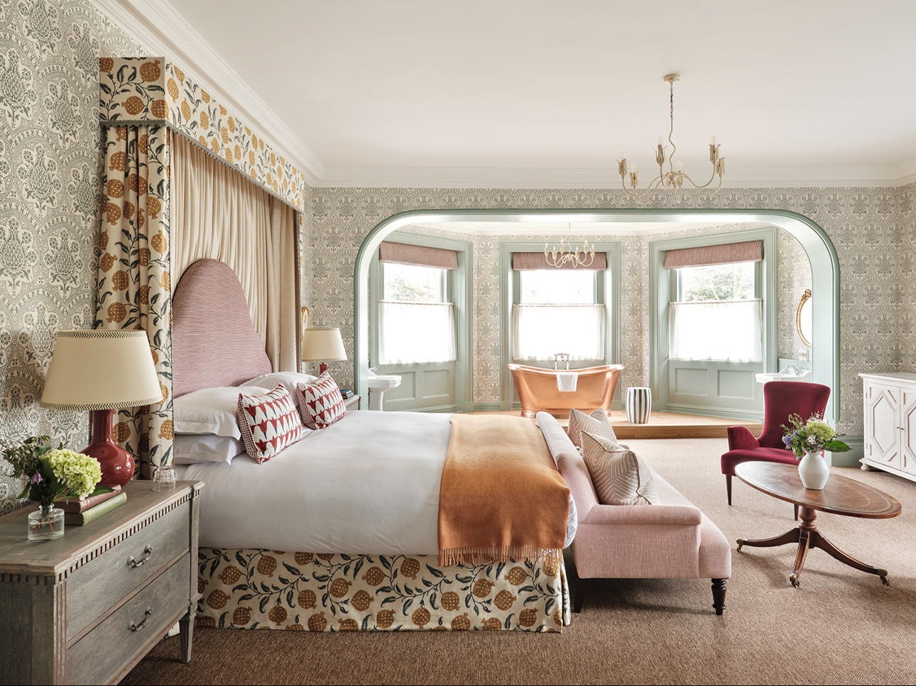 opulent bedroom suite, pastel tones, copper bath in room, sofa at end of bed
