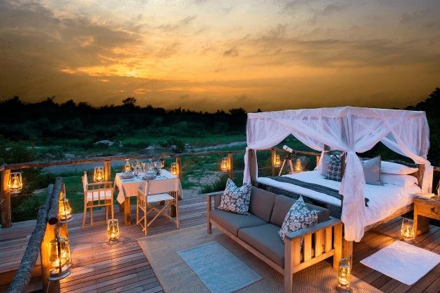 A bedroom on a decking surrounded by countryside