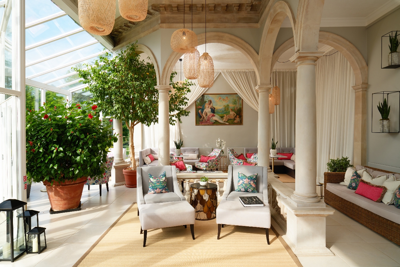 conservatory with arm chairs, and architecture pillars and glass windows