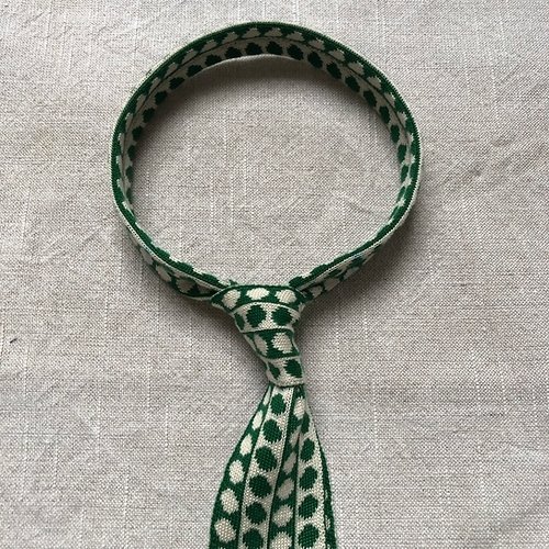 A green polka dot tie