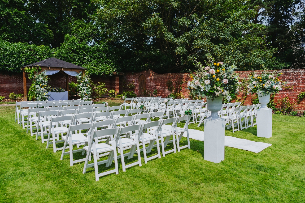 outdoor ceremony area with white chairs