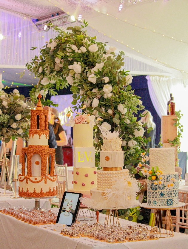 a cake stand at a fair with six cake designs on
