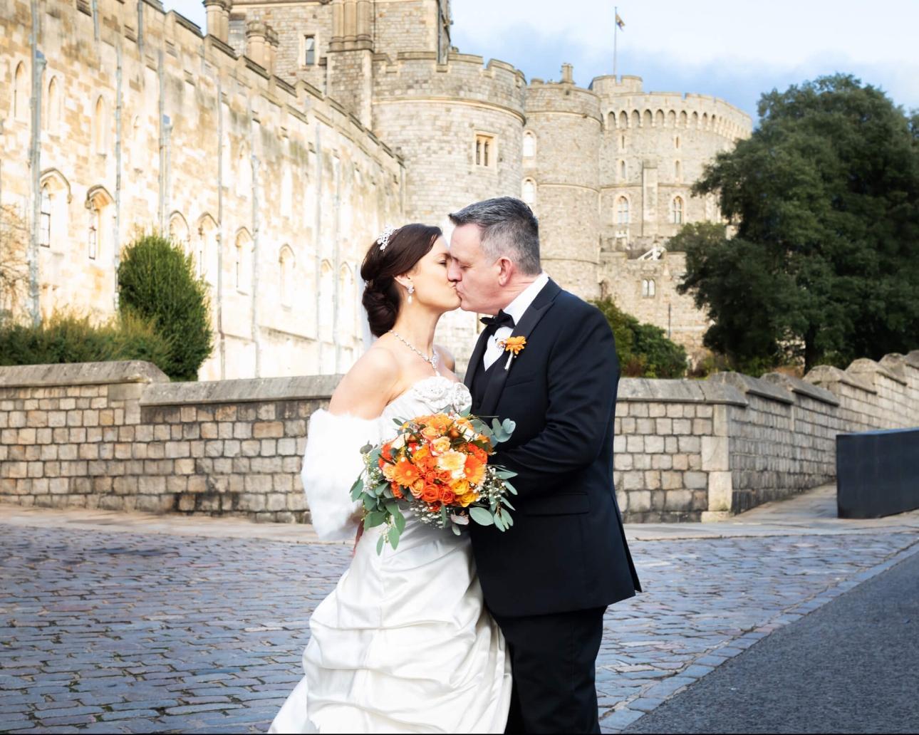 bride and groom in front of castle